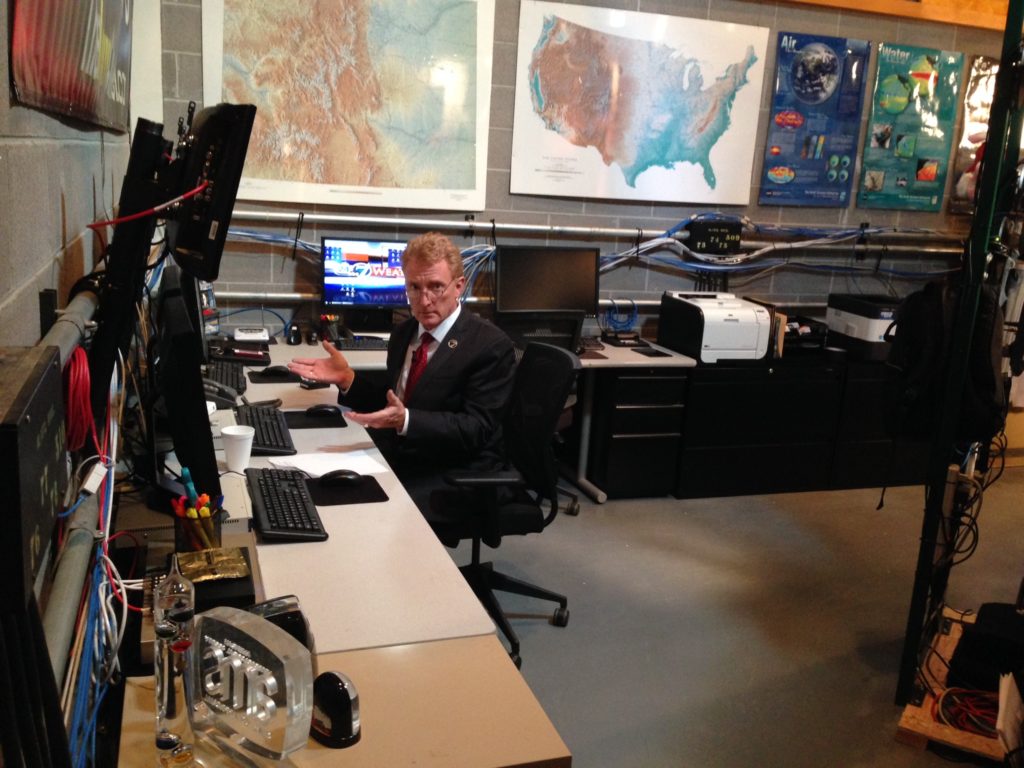 Meteorologist Mike Nelson working in  backstage weather center.